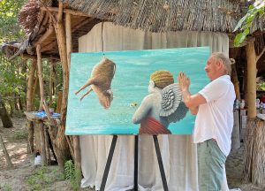 Artist in front of canvas praying