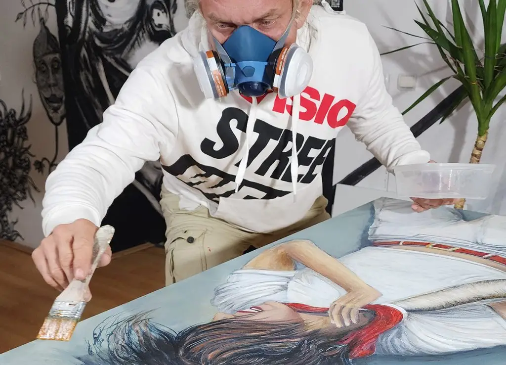 artist wearing mask while glaze surreal painting