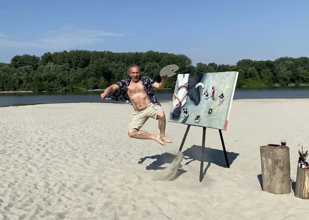 artist jumping in front of painting on shore of danube